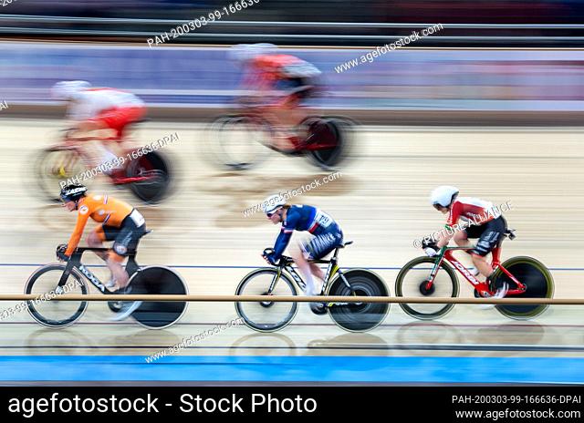 01 March 2020, Berlin: Cycling/track: Point race, women: Kirsten Wild from the Netherlands (below l-r) rides ahead of Victoire Berteau from France and Maria...