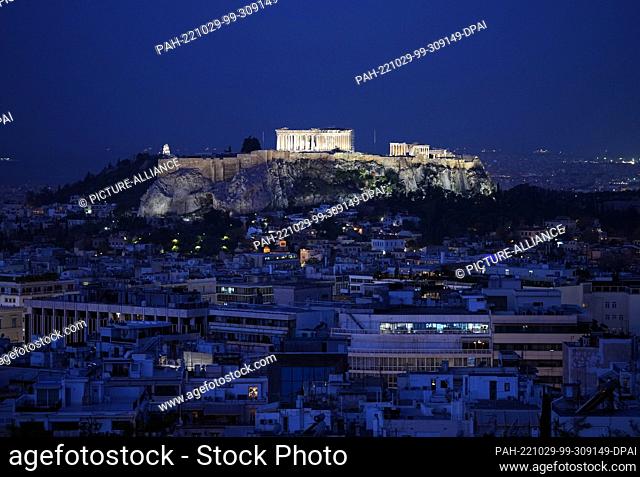 27 October 2022, Greece, Athen: The Acropolis with the Parthenon on a rock above the city is illuminated at night. Photo: Soeren Stache/dpa