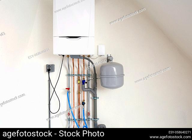 New gas boiler, Heating system with copper pipes, valves and other equipment in a boiler room gas heater system, modern in new house white wall