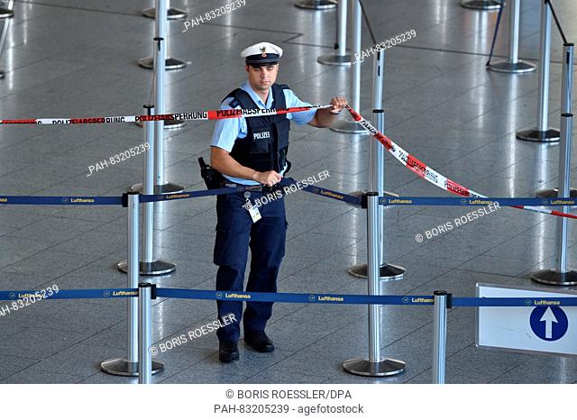 A policeman stretches barrier tape in the departure area of Frankfurt airport in Frankfurt on the Main,  Germany, 31 August 2016