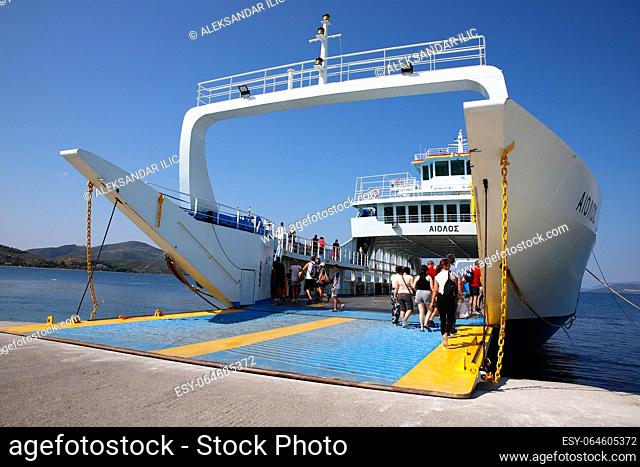 Agiokampos, Evia island, Greece - August 15, 2023: People on summer vacation entering ferryboat at Agiokampos, Evia ilsand
