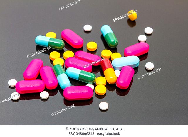 Many pills and tablets on black background for decorate and design project