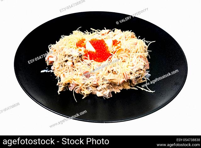served Quail Nest salad from ham, veal and beef tongue, grated cheese, dressed with mayonnaise and decorated by quail egg and salmon caviar on black plate...