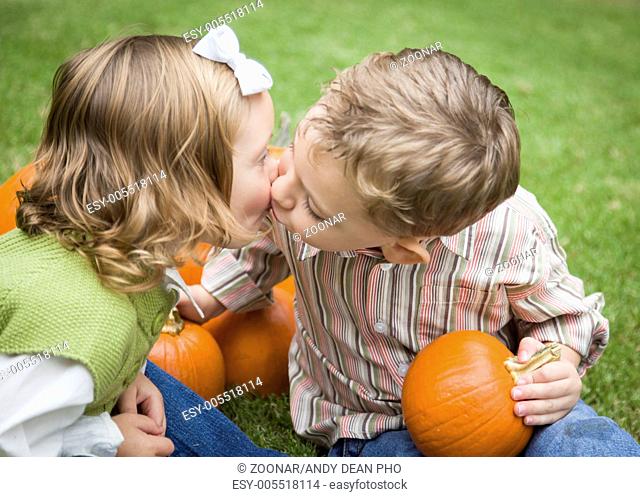 Young Brother and Sister Kiss At Pumpkin Patch