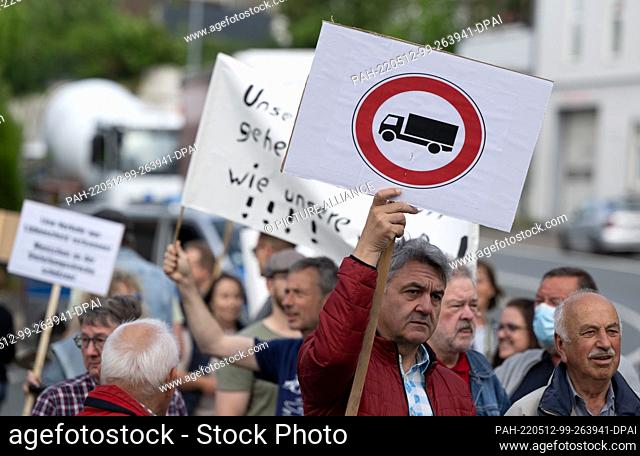 12 May 2022, North Rhine-Westphalia, Lüdenscheid: A sign ""Passage for trucks prohibited"" is printed on a poster at a demonstration against the burden of the...
