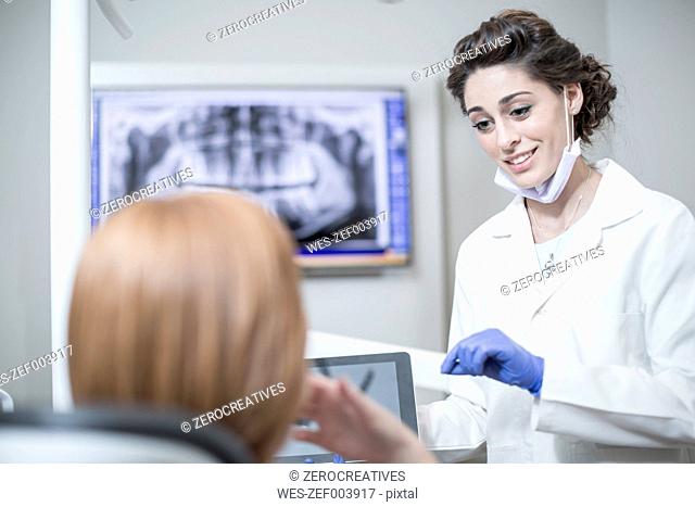 Dentist explaining a procedure and results with a patient