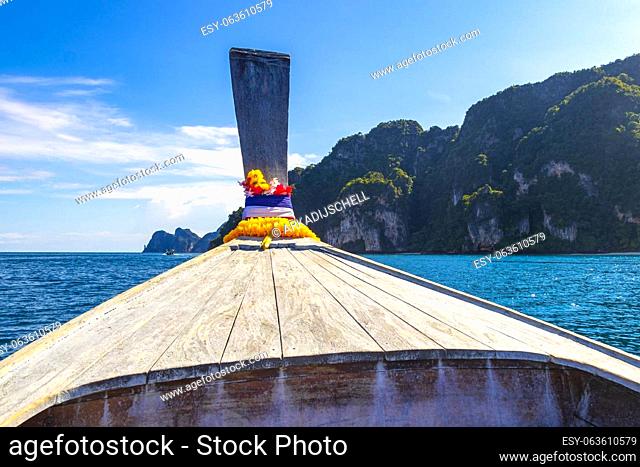 Longtail boat boats at the beautiful famous beach lagoon between limestone rocks and turquoise water on Koh Phi Phi Don island in Ao Nang Amphoe Mueang Krabi...