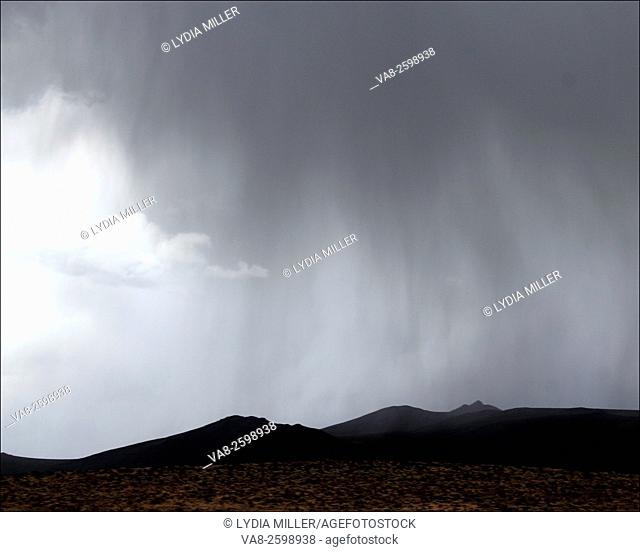 Rain begins to fall in the high desert mountains and sage brush covered terrain near Elko, Nevada
