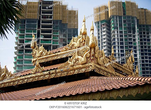 Dhammikarama Burmese Temple, Burmese Temple, Penang Island, George Town, Malaysia on June 15, 2016. Tradition, modern, traditional, gold, golden, skyscraper