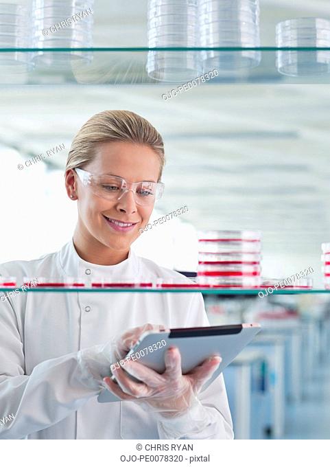 Scientist using tablet computer in lab