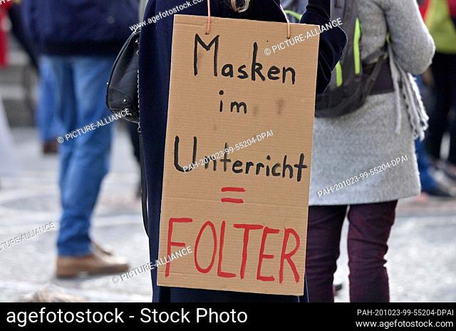23 October 2020, Bavaria, Munich: With posters with the inscription ""Masks in class - torture"" several hundred people demonstrate at Odeonsplatz against the...