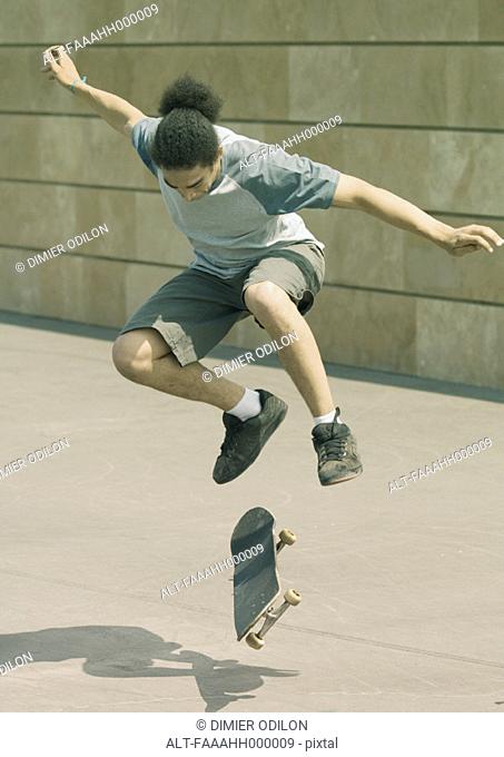 Young man doing trick on skateboard