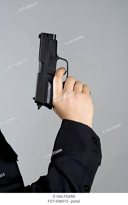 A hand holding a gun