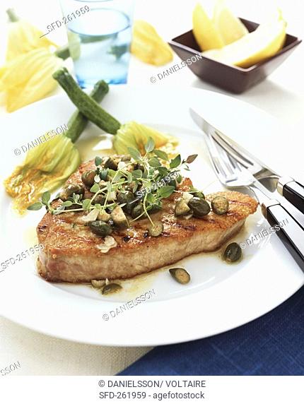 Tuna steak with capers and courgette flowers Italy