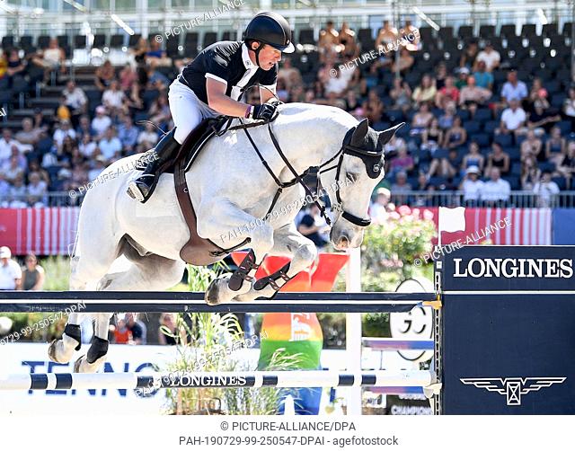26 July 2019, Berlin: Equestrian sports/jumping: Global Champions Tour: Gerco Schröder from the Netherlands on the horse Glock's Cognac Champblanc jumps over an...