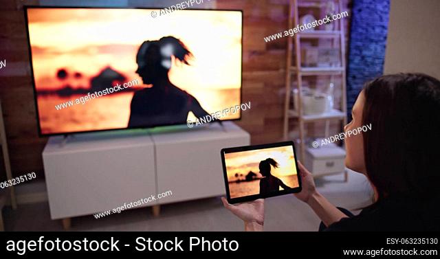 Woman Watching TV Through Tablet Television And Movie Streaming