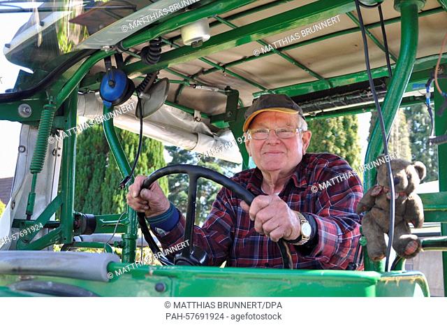 Winfried Langner, also known as Tractor Willi, sits in his, 1961 Marke Deutz tractor, which pulls his camper, in Lauenfoerde, Germany, 21 April 2015