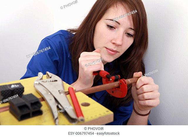 red-haired girl working as plumber