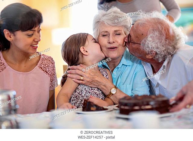 Grandparents celebrating a birthday with their granddaughter