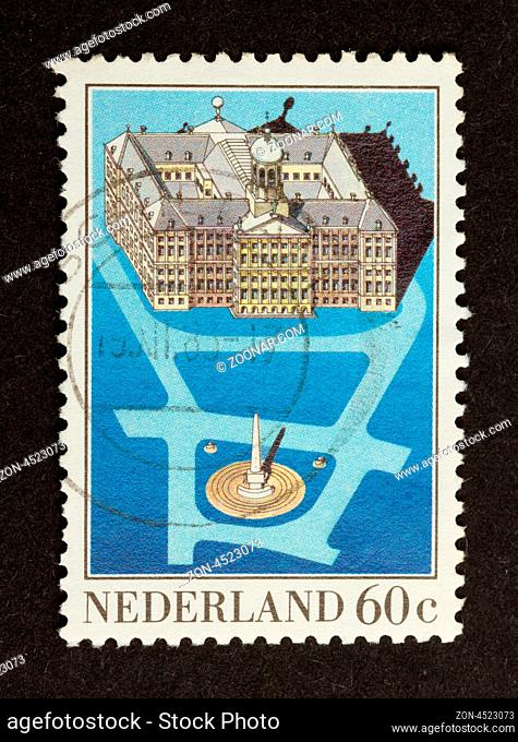 HOLLAND - CIRCA 1980: Stamp printed in the Netherlands shows a large building in Amsterdam, circa 1980