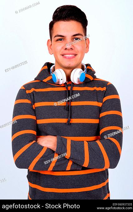 Studio shot of young handsome multi ethnic man wearing hoodie against white background