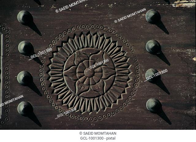 Arabesque details engraved on a wooden door