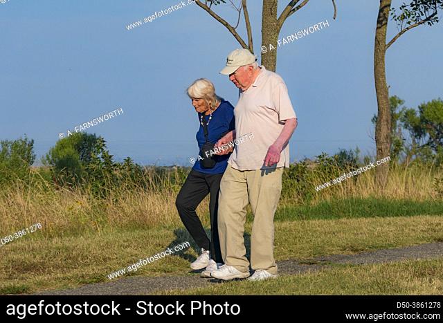 Point Lookout, Maryland, A senior couple walk on a path holding hands