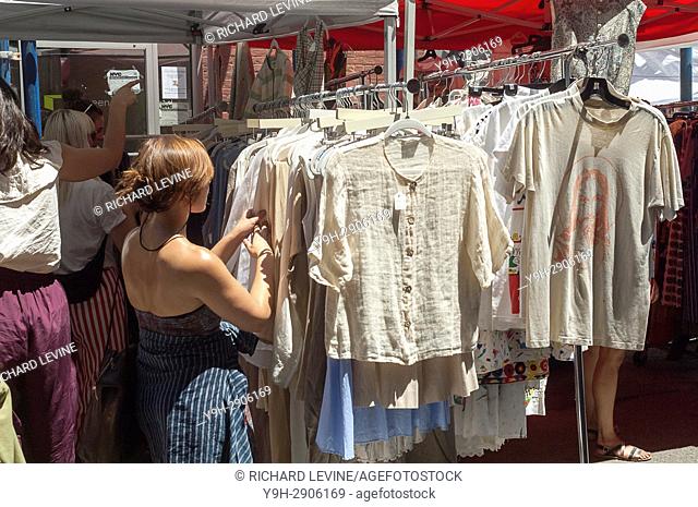 Shoppers browse second-hand merchandise at the Brooklyn Flea in the neighborhood of Dumbo in Brooklyn in New York