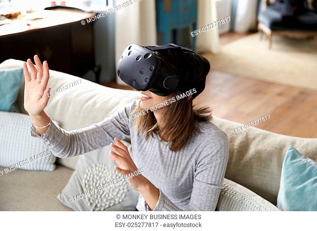 Young Woman Wearing Virtual Reality Headset In Studio