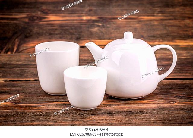 White porcelain tea set on wooden background