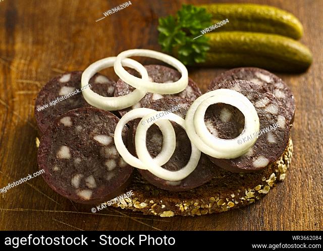 Slice of bread with blood sausage and onion rings, close-up