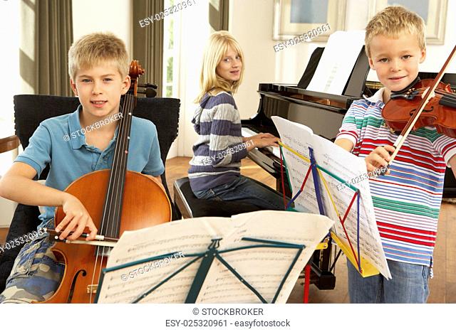 Children playing musical instruments at home