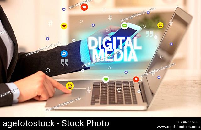 Freelance woman using laptop with DIGITAL MEDIA inscription, Social media concept