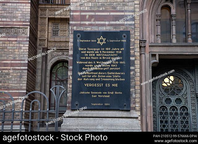 12 May 2021, Berlin: A commemorative plaque hangs on the façade of the New Synagogue in Berlin-Mitte. During the night, Israeli flags were set alight in front...
