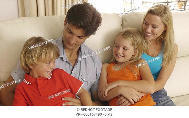 Medium shot of family sitting on couch together, Sotogrande, Spain