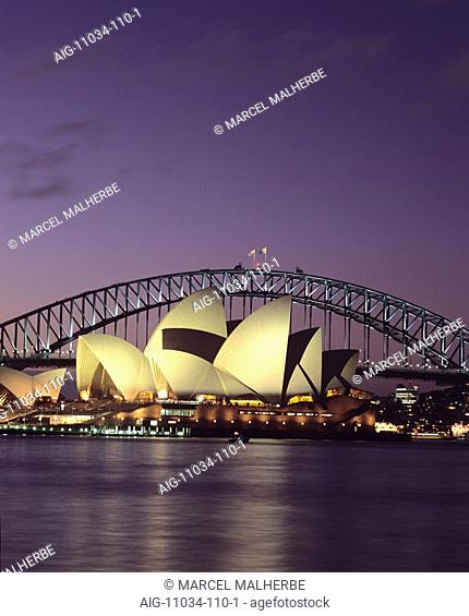 Opera House with Harbour Bridge in background, Sydney. Exterior at dusk