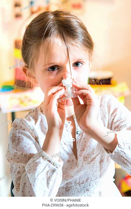 5 year-old girl blowing nose