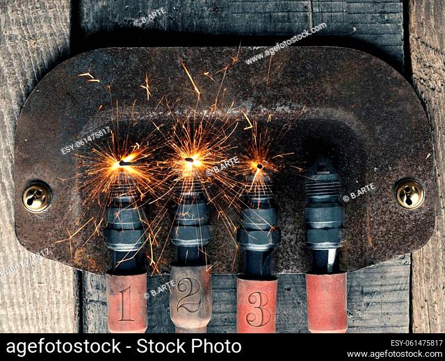 Third Advent background with four spark plugs on rusty sign, car workshop advent, concept image