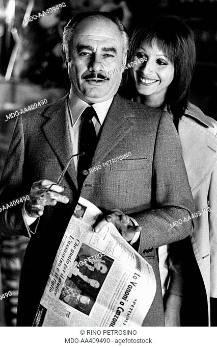 Martin Balsam and Paola Pitagora on the movie set of The True and the False. American actor Martin Balsam holding a newspaper with an article about Ornella...