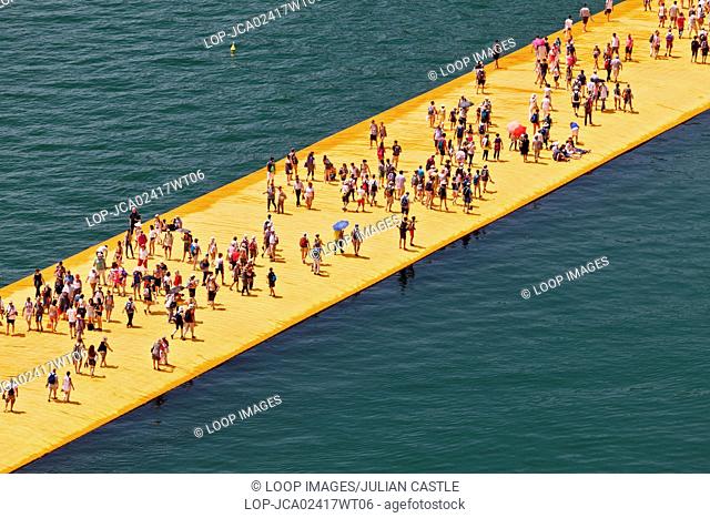 View from above of crowds of people on the Floating Piers Project for Lake Iseo which is an artwork by Christo and Jeanne Claude