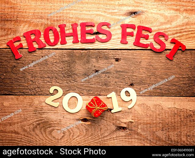 Old wooden plank with the German words Merry Christmas, holiday concept background