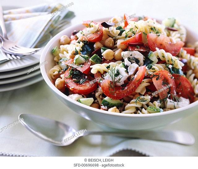 Fusilli pasta with olives, feta cheese, dill, tomatoes, cucumber and chickpeas