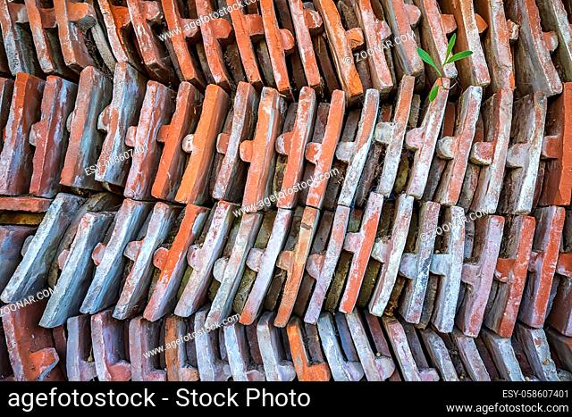 Sorted stacks of old roof tiles in a yard