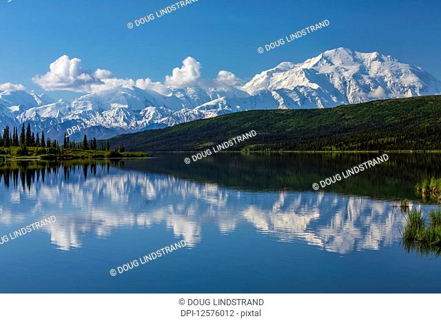Denali shows well with the blue waters of Wonder Lake, Denali National Park and Preserve, Interior Alaska; Alaska, United States of America