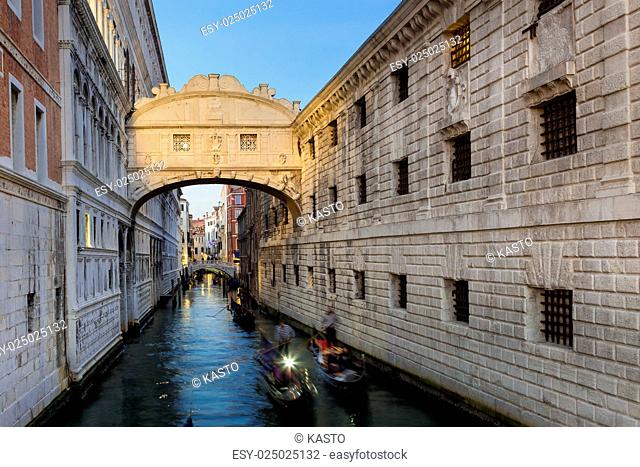 Gondolas passing under Bridge of Sighs, Ponte dei Sospiri. A legend says that lovers will be granted eternal love if they kiss on a gondola at sunset under the...