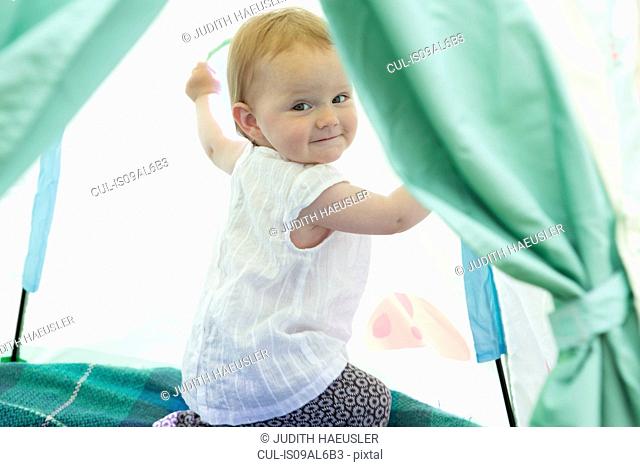 Baby girl playing in tent