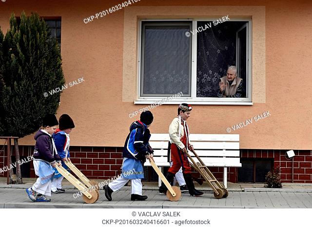 Children in moravian traditional dress walk with their rattles through the centre of Lanzhot, Czech Republic on Maundy (Holy) Thursday, March 24, 2016