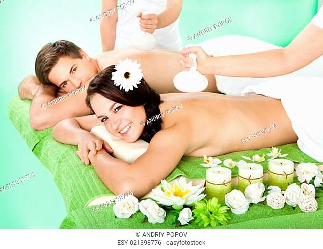 Couple Receiving Massage With Herbal Compress Balls