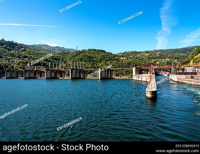 Solid structure of the Carrapatelo dam on River Douro in Portugal with the lock gates on the right