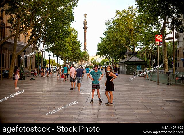 tourists walk famous la rambla street in barcelona, spain. the most popular street in barcelona